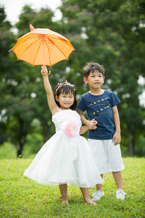 Asian brother and sister having fun in the parkの写真素材