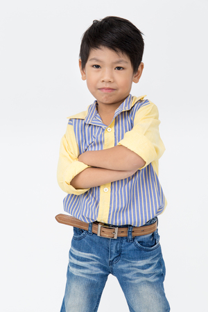 Portrait of Happy asian boy with smile face on gray backgroundの写真素材
