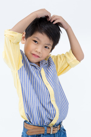 Portrait of Happy asian boy with smile face on gray backgroundの写真素材