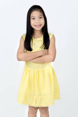 Portrait of Little asian girl with smiles face ,isolated on gray backgroundの写真素材