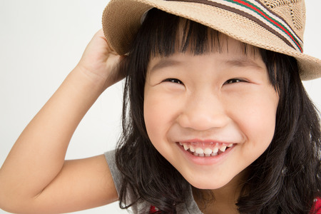 Portrait of Little asian girl with smiles face ,isolated on gray backgroundの写真素材