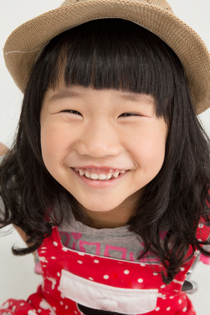 Portrait of Little asian girl with smiles face ,isolated on gray backgroundの写真素材