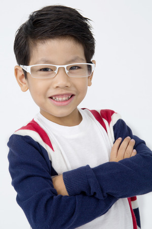 Portrait of asian cute boy with smile face, on gray backgroundの写真素材