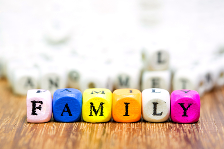 Wood dice with Words FMAILY mean Father And Mother I Love You on wooden tableの写真素材