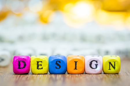 Wood dice with Words DESIGN on wooden table ,Inspiration concept