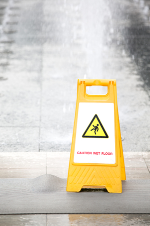 Sign showing warning of caution wet floorの写真素材