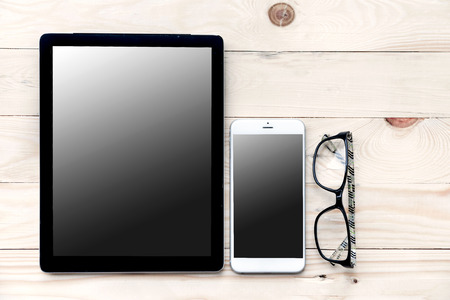 High angle view of businessman desk with organizer, glasses and tablet. Top view of office supplies on wooden board background with copy space.の写真素材