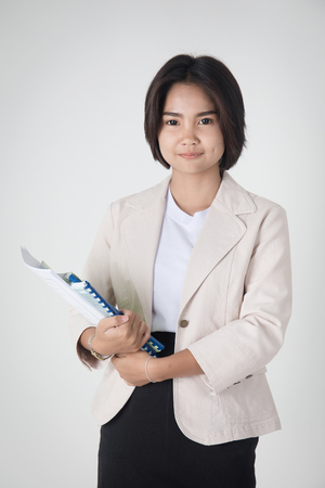 Portrait of Happy asian student with stationery tool on gray backgroundの写真素材