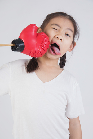 Asian girls studio portrait acting on your face , on gray backgroundの写真素材