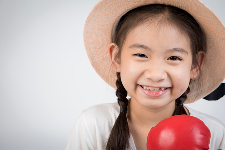 Headshot Portrait of happy cute girl smiling looking at camera. on gray background.の写真素材