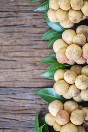 LangSat Thai fruit with green leave on wooden background, And space for add your Textの写真素材