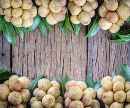 LangSat Thai fruit with green leave on wooden background, And space for add your Textの写真素材