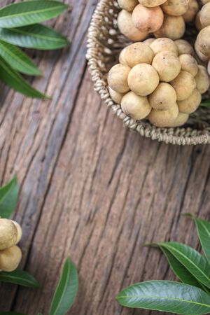LangSat Thai fruit with green leave on wooden background, And space for add your Textの写真素材