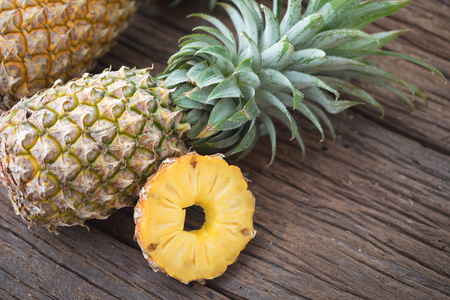 Pineapple slice with copy space on the wood texture backgroundの写真素材