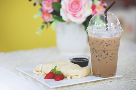 Close up of french style crepes with a cup of coffee, shallow dof. の写真素材