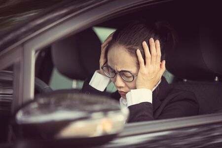 Stressed of asian woman driver sitting inside her car