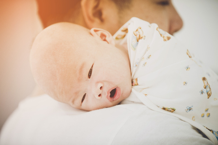Asian father and baby son plays, hugging, playing at home ,Lovely momentの写真素材