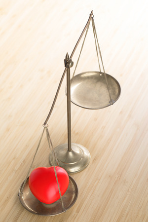 Abstract of red heart on balance brass .の写真素材