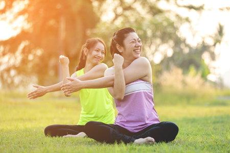 Young asian happy woman exercising in park on beautiful day.の写真素材