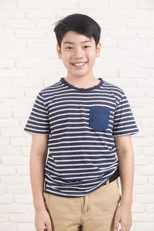 Portrait of asian cute girl looking at camera on gray background.の写真素材