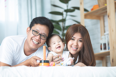 Happy asian family father mother with daughter looking camera with smile face.の写真素材