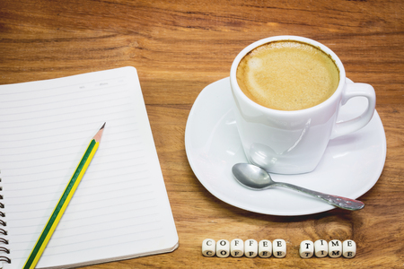 Times of coffee,Cup of coffee with note book and pencilの写真素材