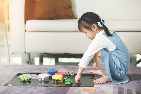 Asian child playing alone in your home.の写真素材