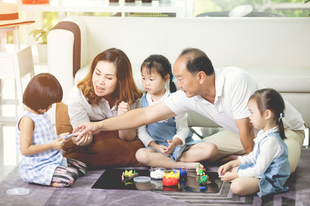 Happy asian family father and mother enjoying with child, Family lifestyle at homeの写真素材