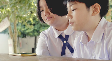 Asian child watching on tablet computer together .の写真素材
