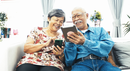 Asian Senior couple e-shopping with digital tablet, Senior couple online shopping with smile face.の写真素材