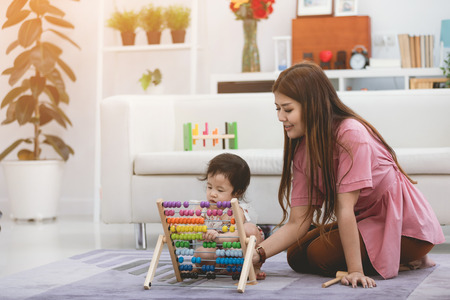 Portrait of asian mother and her daughter lifestyle image at home.の写真素材