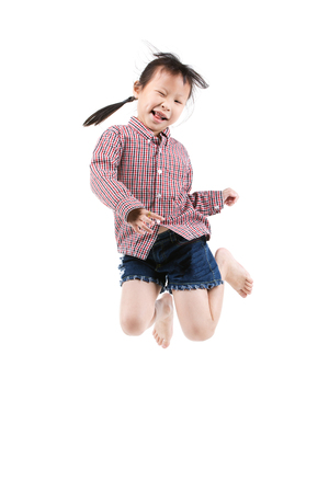 Portrait of happy little Asian child jumping isolated on white background.の写真素材