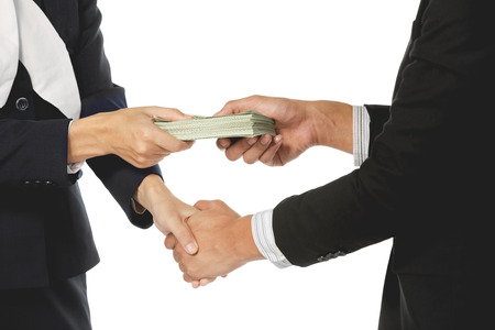 Businessmen making handshake with money in hands isolated on white background. - bribery, corruption...