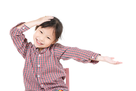 Photo of asian little girl looking at camera with smile face over white background.の写真素材