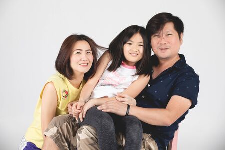 Portrait of happy family parent and child isolated on gray background.