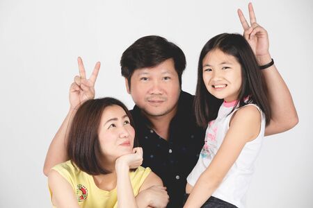 Portrait of happy family parent and child isolated on gray background.