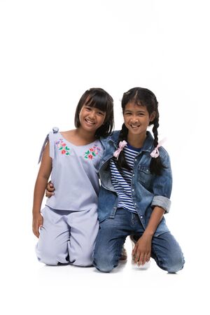 Photo of asian little girl looking at camera with smile face over white background.の写真素材
