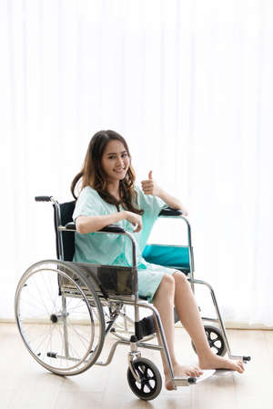 Sad and depressed asian woman in a wheelchair . Copy space on the window.の写真素材