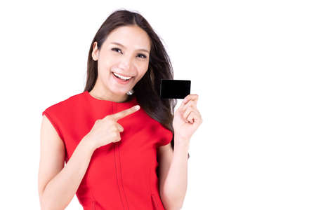A beautiful woman in a red dress Showing a happy expression On a white background, A lovely woman holding a name card and point her hand to show somethingの写真素材