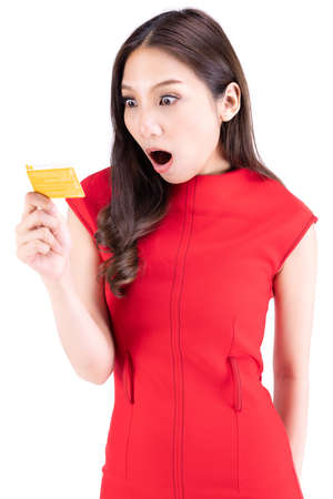 Portrait beautiful woman in a red dress , Frightened expression I was looking at something on my hand. On a white backgroundの写真素材