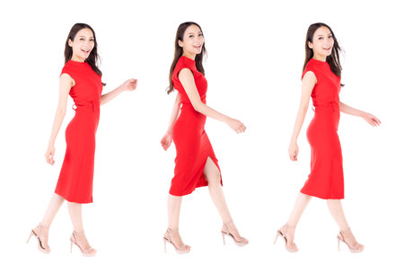 Portrait beautiful woman in a red dress walking with happy expression On a white background.の写真素材