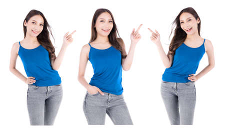 Asian young beautiful female hold hands up and finger point and look up smiling on white background.の写真素材