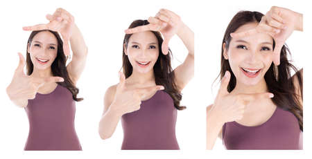 Happy woman making frame with fingers isolated on a white backgroundの写真素材