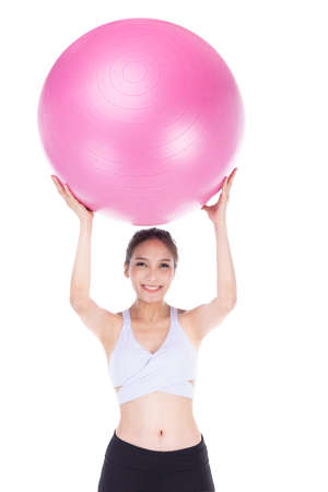 Young asian sporty woman with pink fit ball isolate on white background .の写真素材