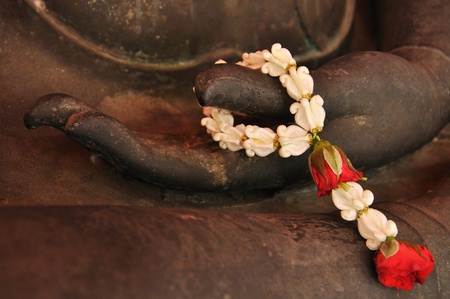 Buddha's hand and garland, the symbol of faith and peaceful の写真素材