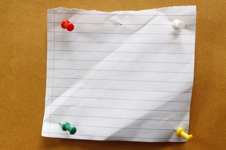 pushpin attached white paper on brown bacckgroundの写真素材