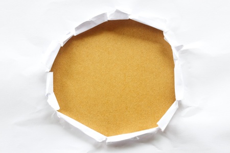 Hole in the paper with torn sides.の写真素材