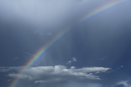 A photography of a blue sky rainbow backgroundの写真素材
