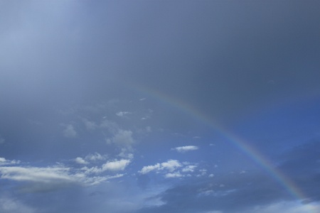 A photography of a blue sky rainbow backgroundの写真素材