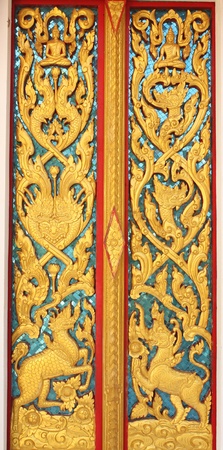 Detail of thai art on door wall  temple in thailandの写真素材